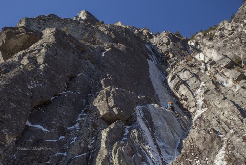 Ryan Stefiuk leading up pitch 1 of P'tite Tête, WI4+R,M6R, on Mont Gros Bras in Parc National des Grand Jardins in Quebec.