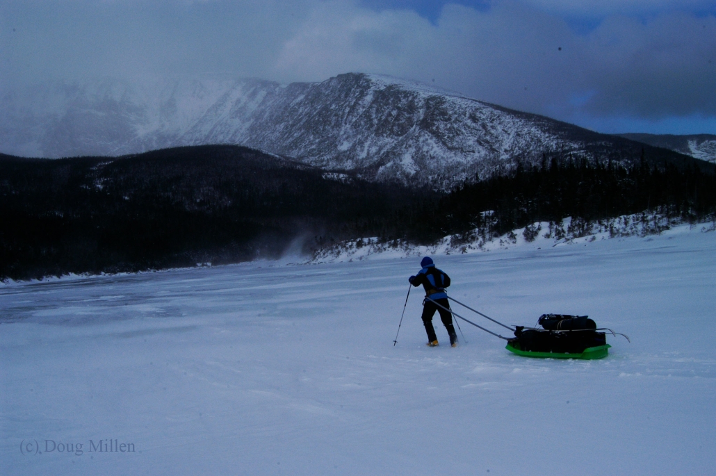 Pam Banks battling a little wind crossing the South Basin Pond on her way to the Chimney Pond cabins - Photo: Doug Millen